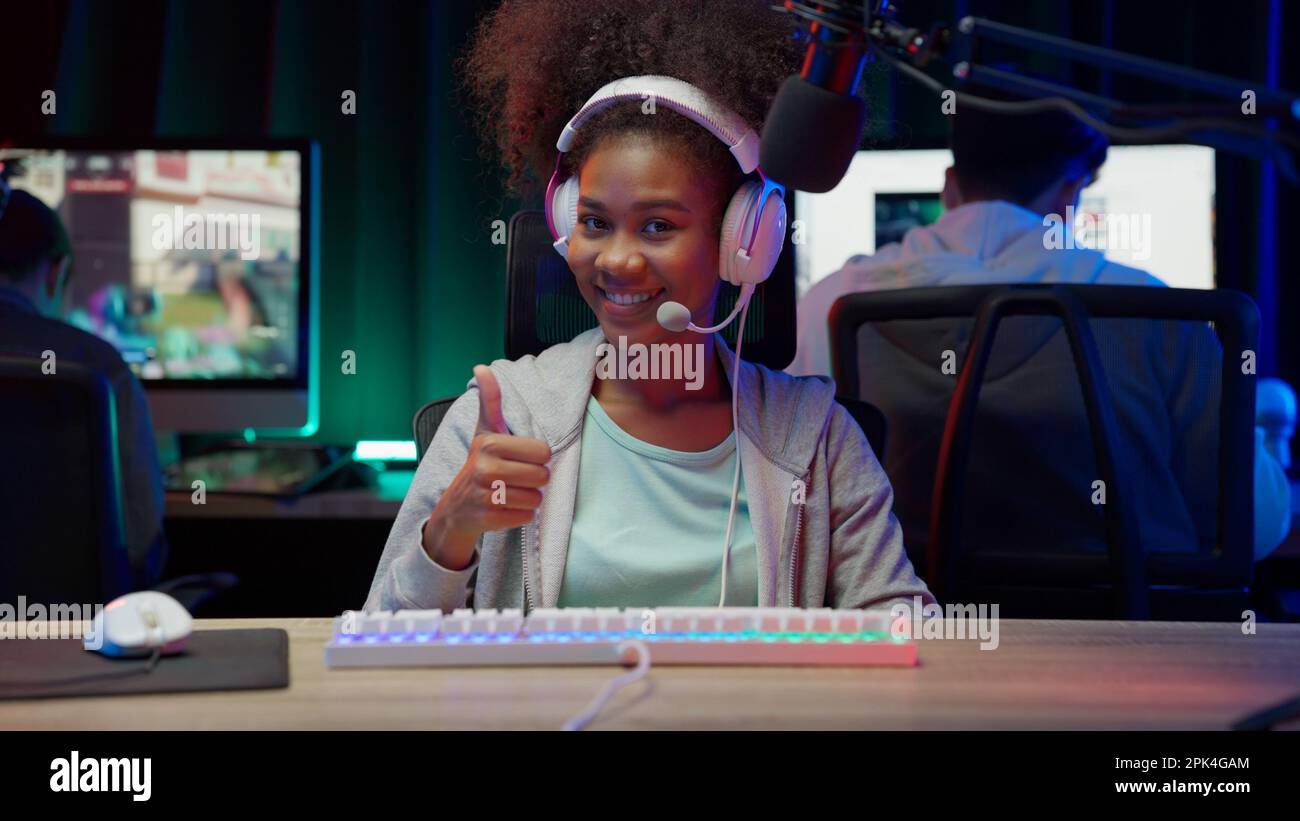 Game streamer using pc setup playing multiplayer first person shooter Stock Photo