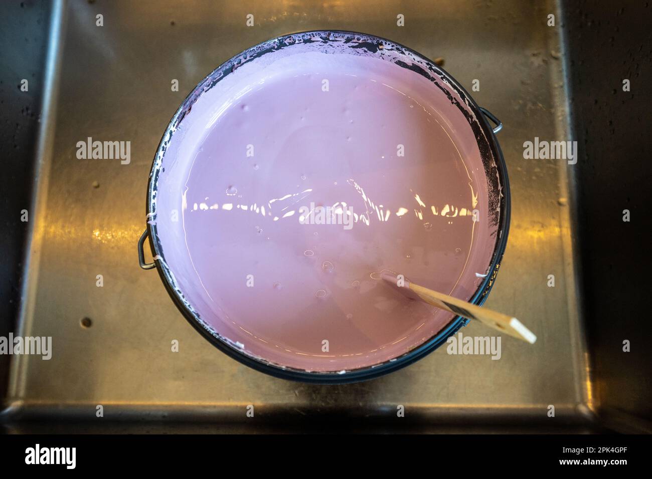 Pink paint being stirred in a bucket Stock Photo Alamy