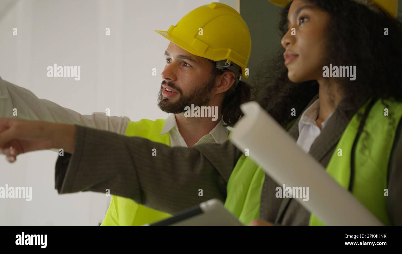 Engineers using tablet talking and brainstorming together on construction site Stock Photo