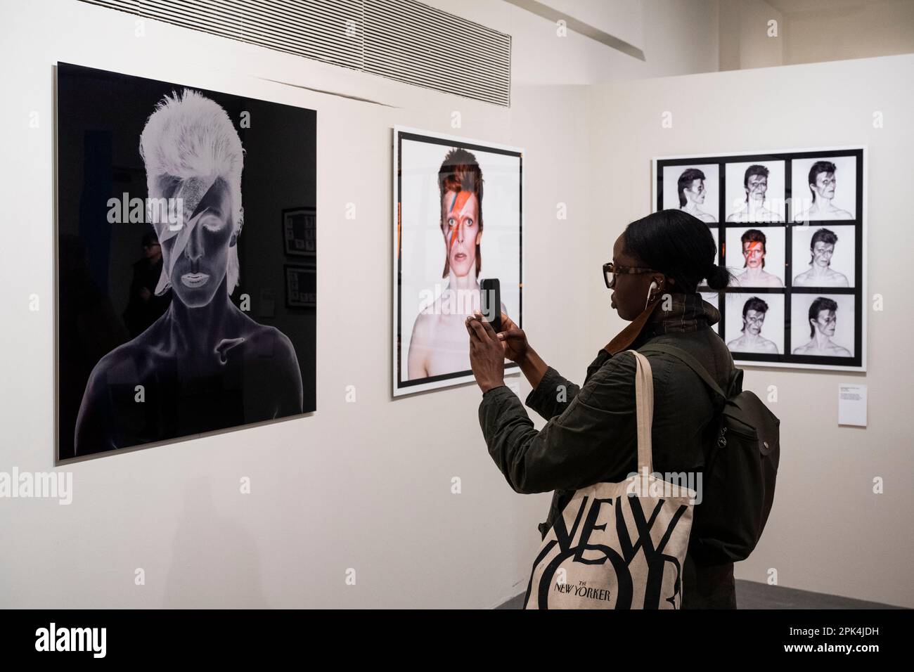 London, UK.  5 April 2023. A staff visitor views (C) 'Aladdin Sane, Eyes Open', 1973, by Brian Duffy, at a preview of ‘Aladdin Sane: 50 Years’, a new exhibition at the Royal Festival Hall at the Southbank Centre.  Fifty years on from the release of David Bowie’s ‘Aladdin Sane’ album, the exhibition explores the iconic ‘lightning bolt’ cover portrait by Brian Duffy and the continuous reshaping of Bowie’s image.  The show runs 6 April to 28 May.  Credit: Stephen Chung / Alamy Live News Stock Photo