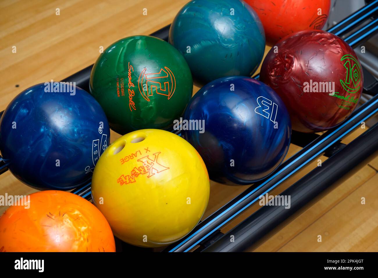 Stand with colorful bowling balls in club no people Stock Photo Alamy