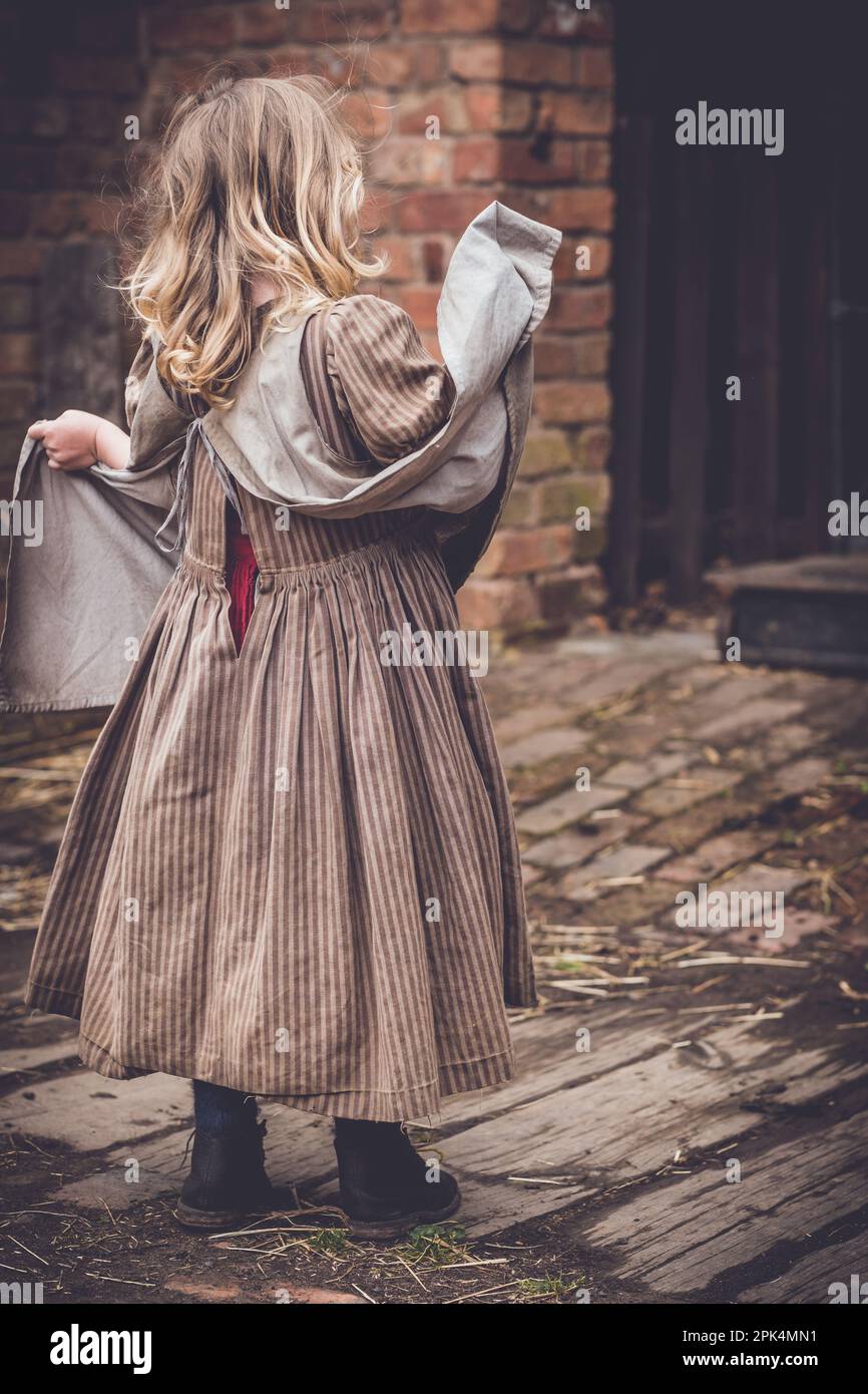 A little girl wearing an old-fashioned brown dress Stock Photo - Alamy A little girl wearing an old-fashioned brown dress Stock Photo - Alamy