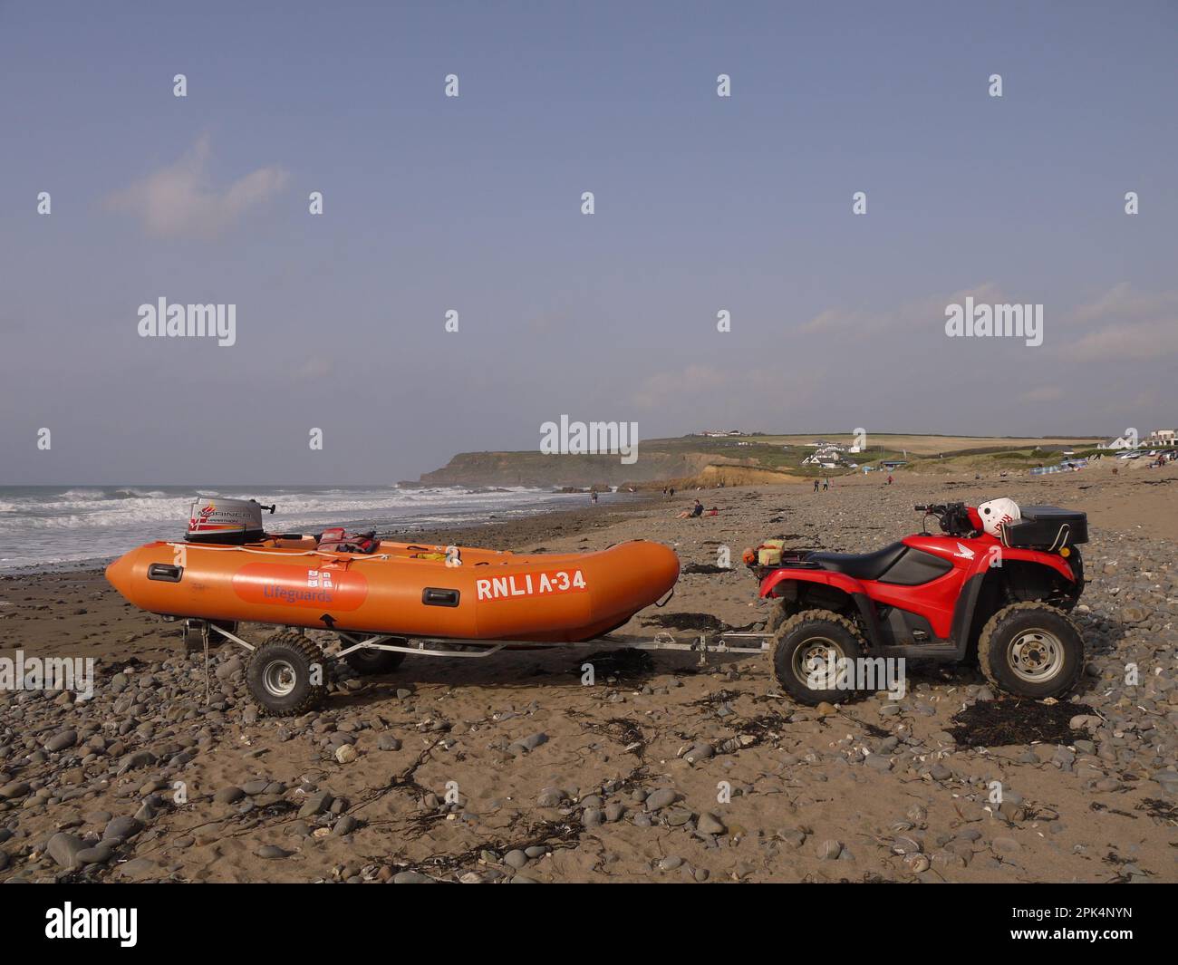 RNLI dinghy on a trailer hitched up to a Honda quad bike on Widemouth