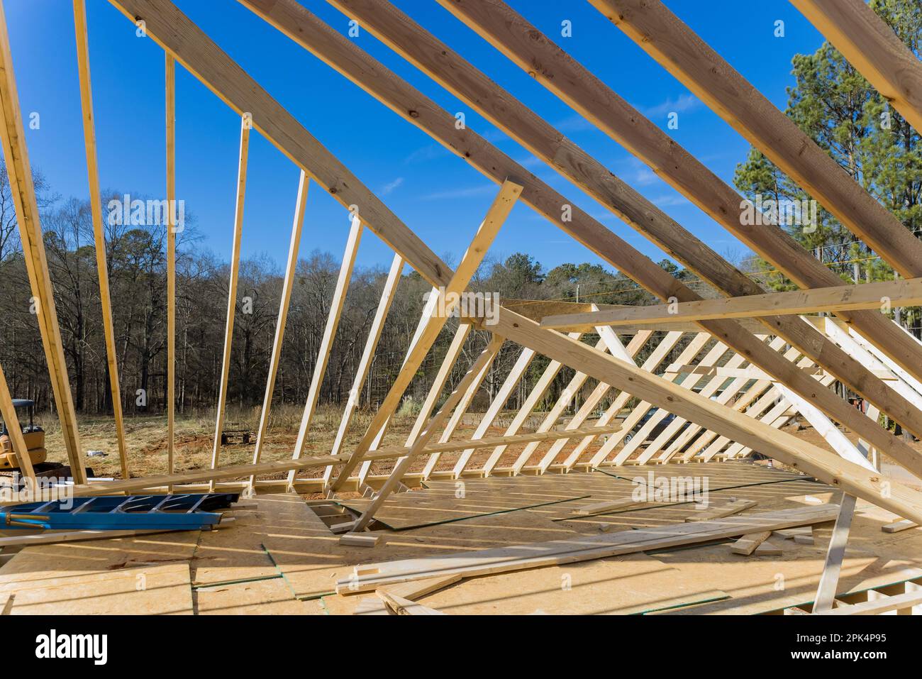 Under construction is timber truss framed building with rafters, roof