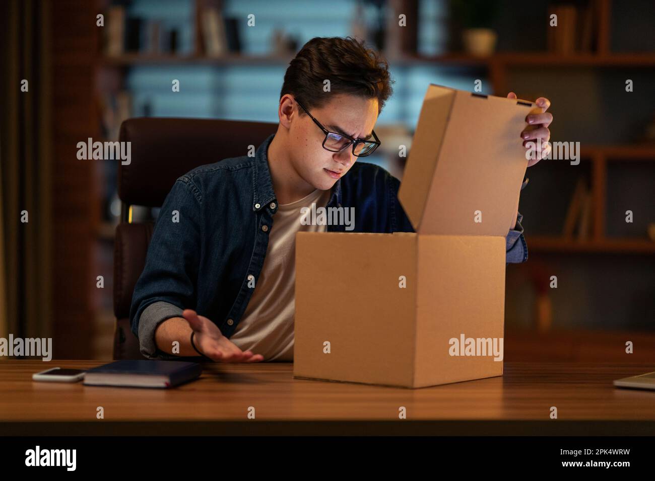 Businessman opening package in office hi-res stock photography and ...