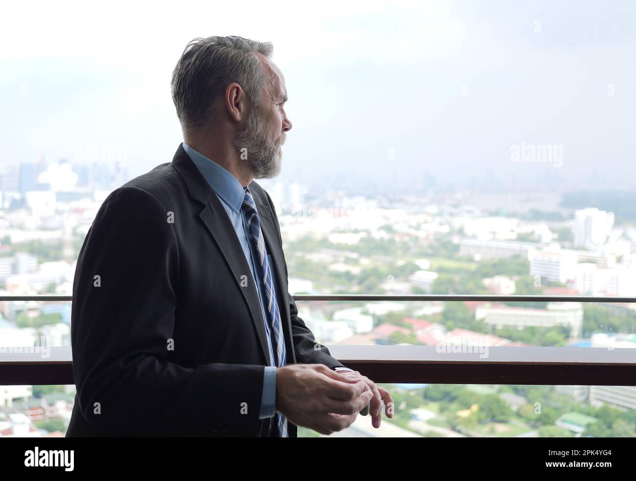 Portrait of businessman standing on high building Stock Photo