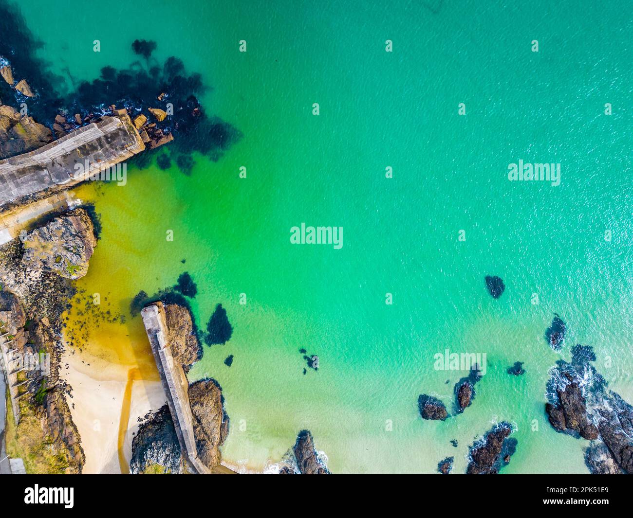 Aerial view of Port of Ness harbour with turquoise water in the Isle of