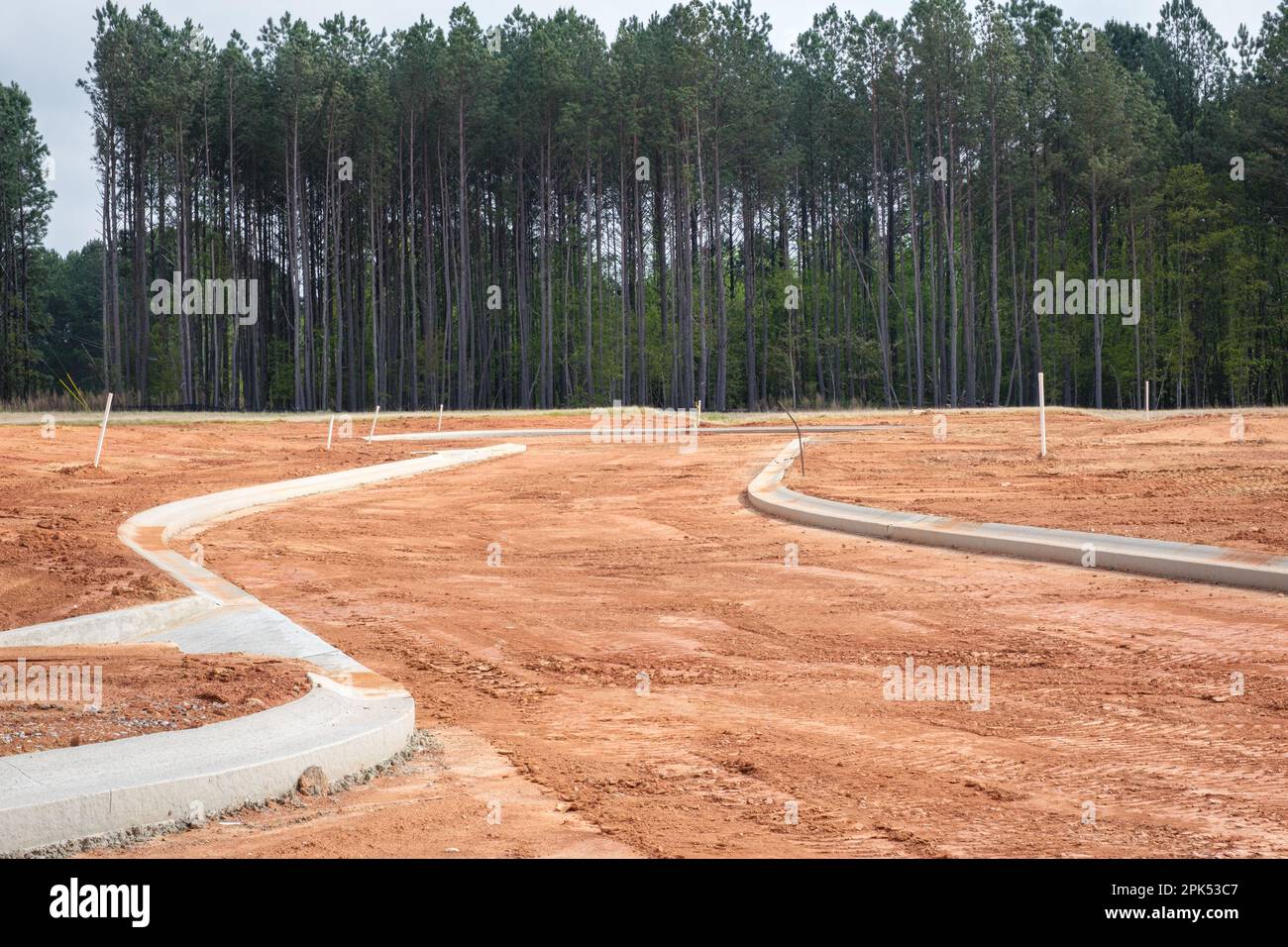 Concrete curbs in new residential subdivision have been poured on red