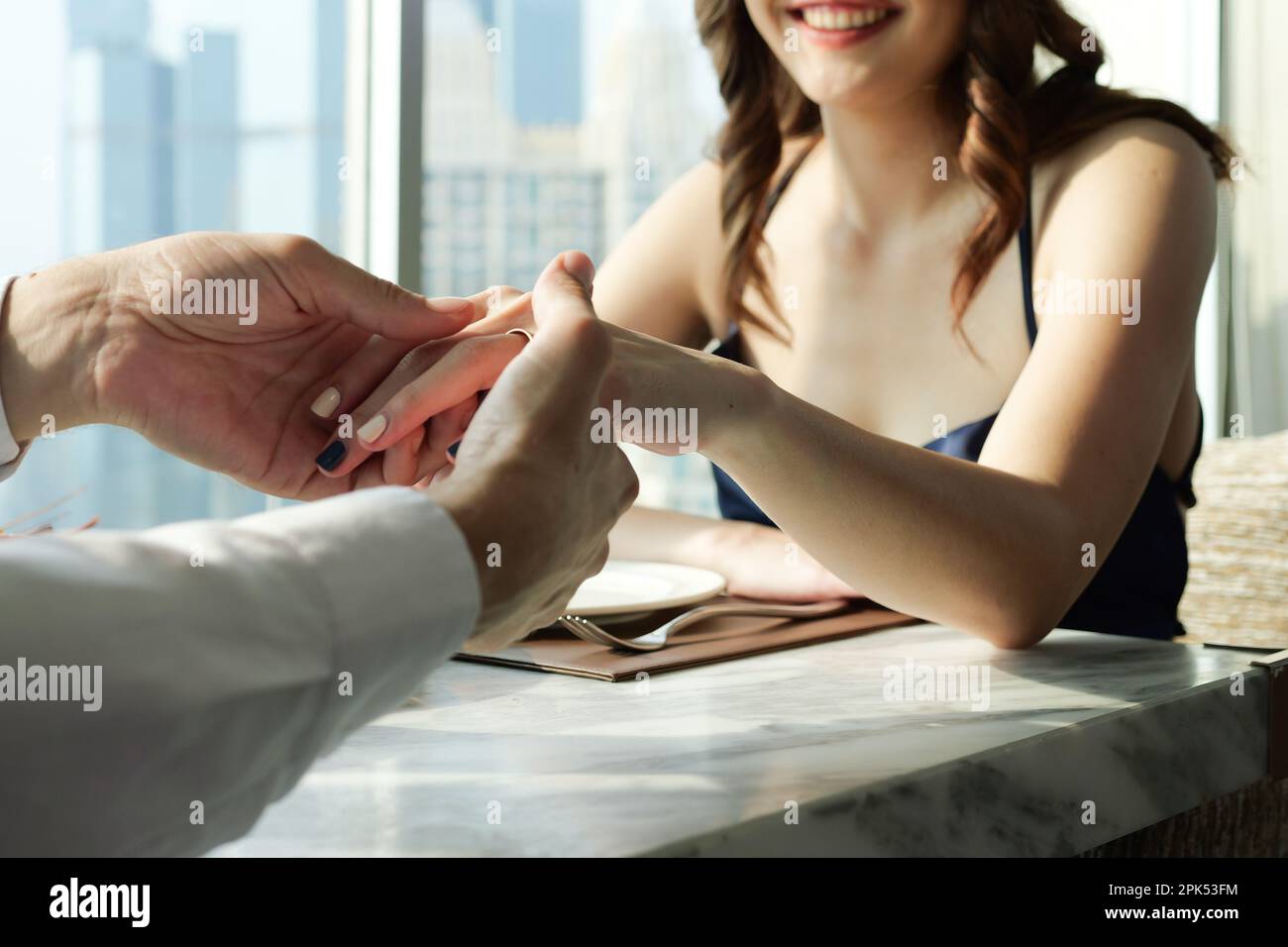 Couple in love having romantic dinner at skyscraper rooftop restaurant bar Stock Photo