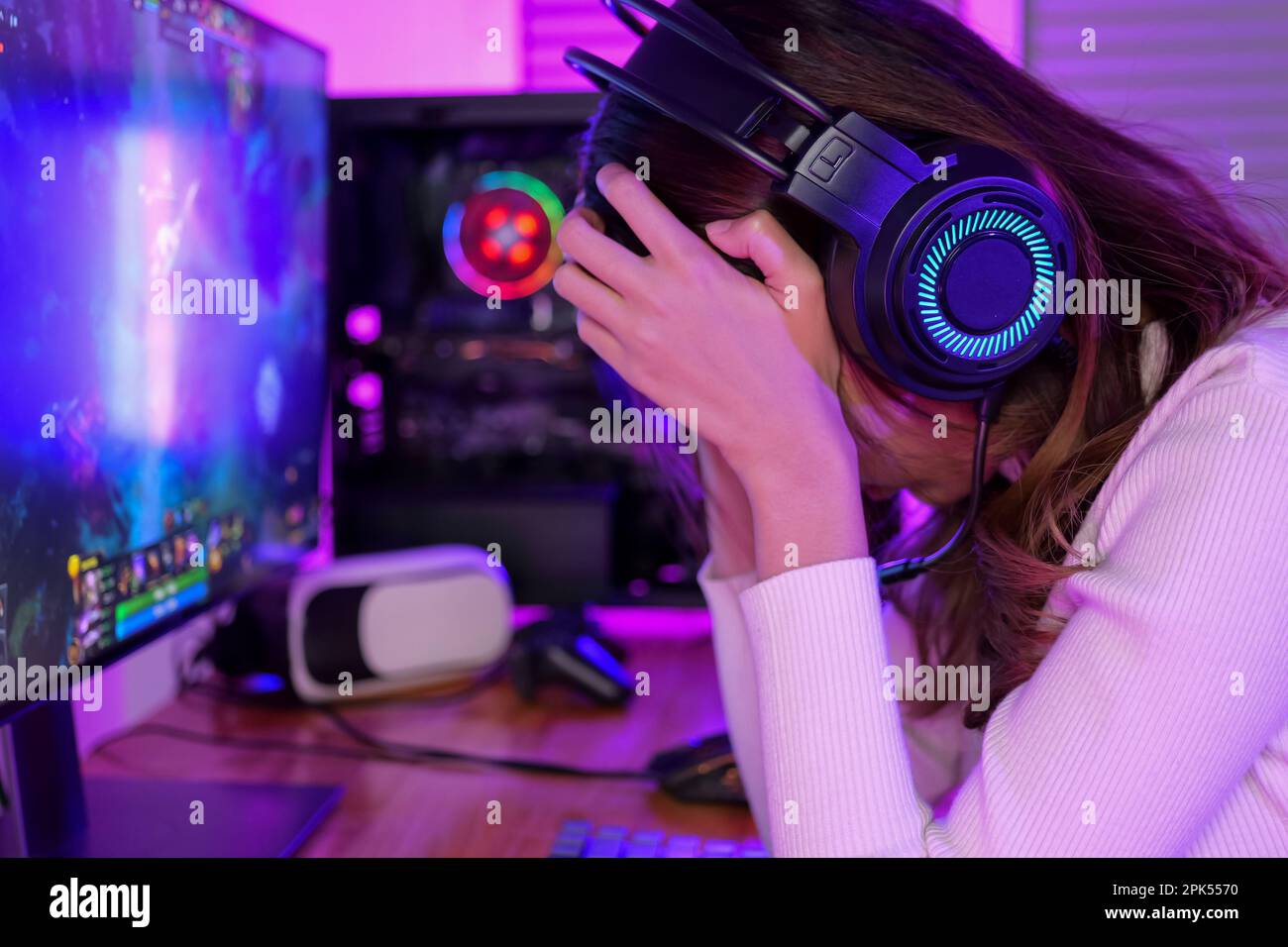 Female gamer having eye strain and headache after lose game Stock Photo