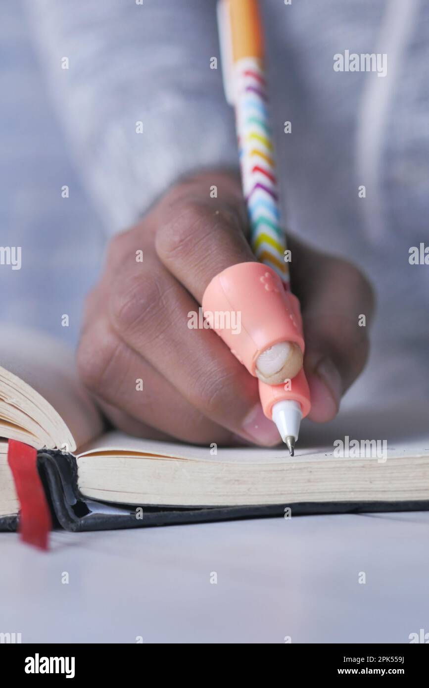 Childing using writing corrector pen holder postures grip stock photo