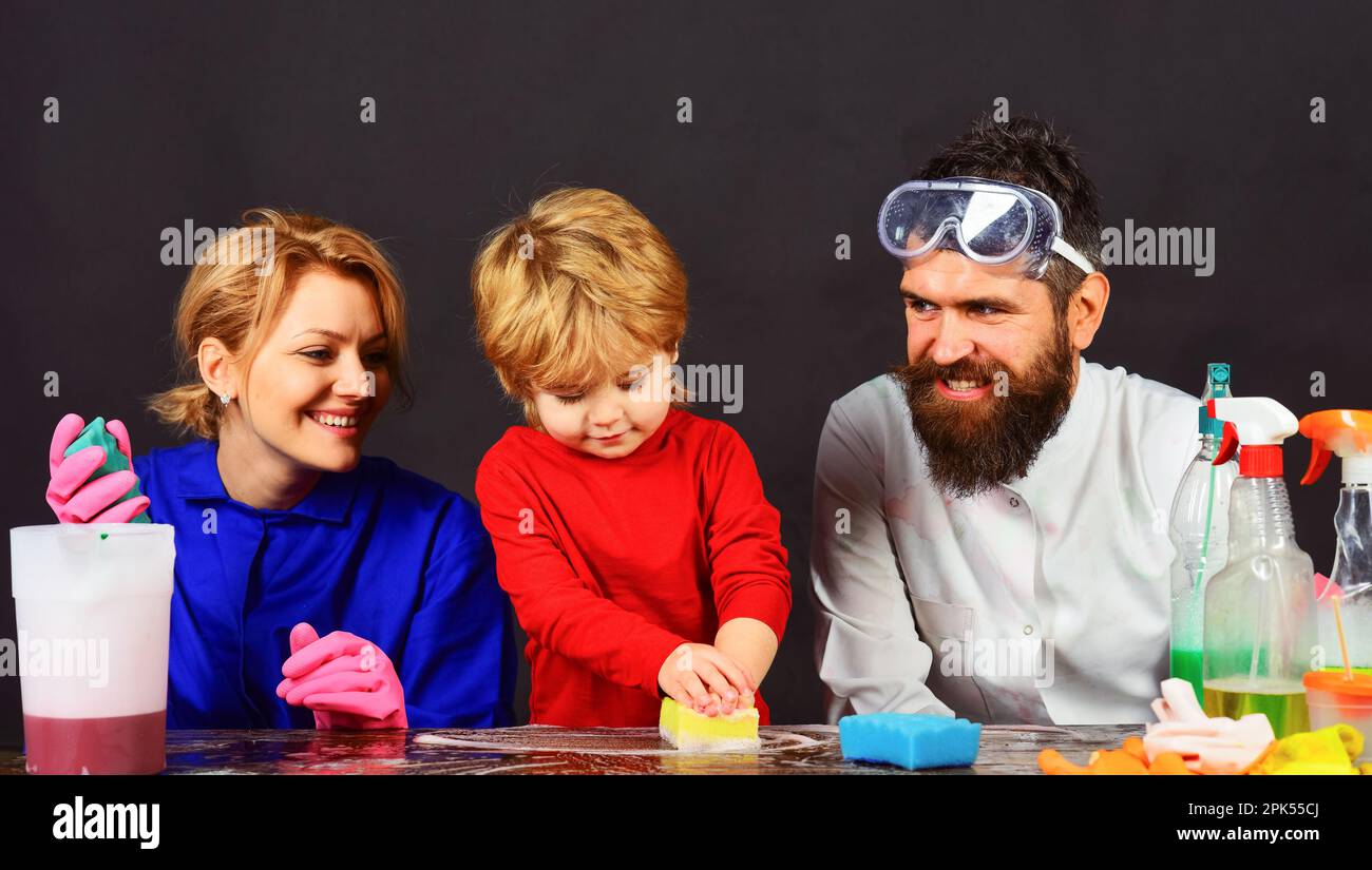 Cleaning day. Family cleaning together. Father, mother and son cleaning home together and having fun. Happy family cleans house. Spring cleaning Stock Photo
