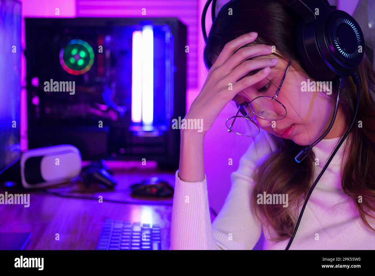 Female gamer having eye strain and headache after lose game Stock Photo