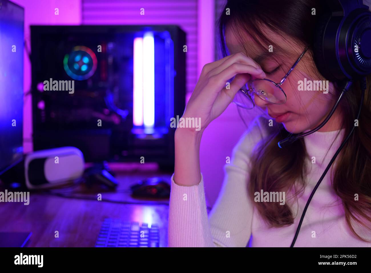 Female gamer having eye strain and headache after lose game Stock Photo