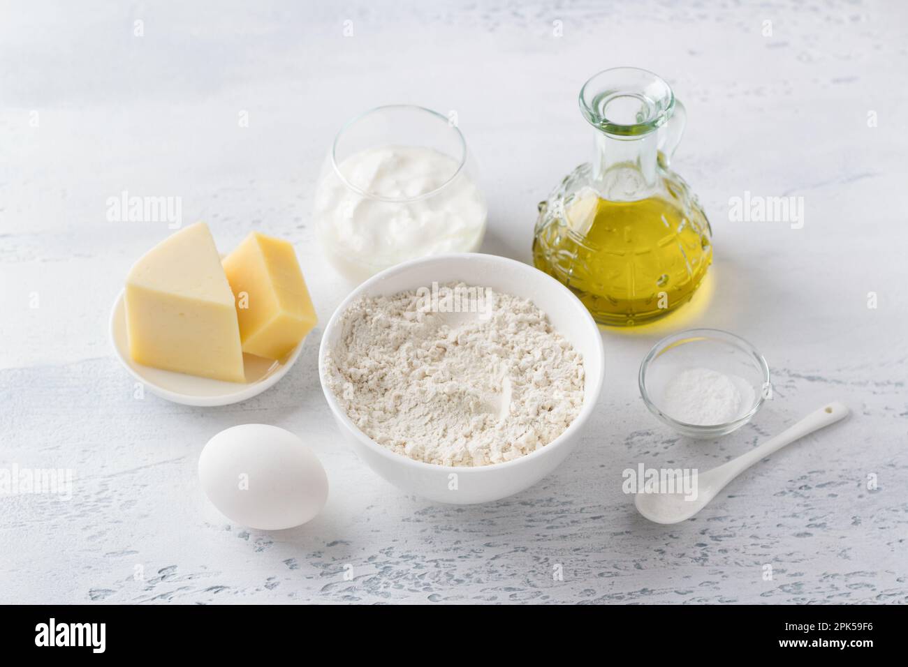 Ingredients for cooking traditional Italian biscotti cheese croutons: wheat flour, natural yogurt, egg, hard cheese, olive oil, salt and baking powder Stock Photo