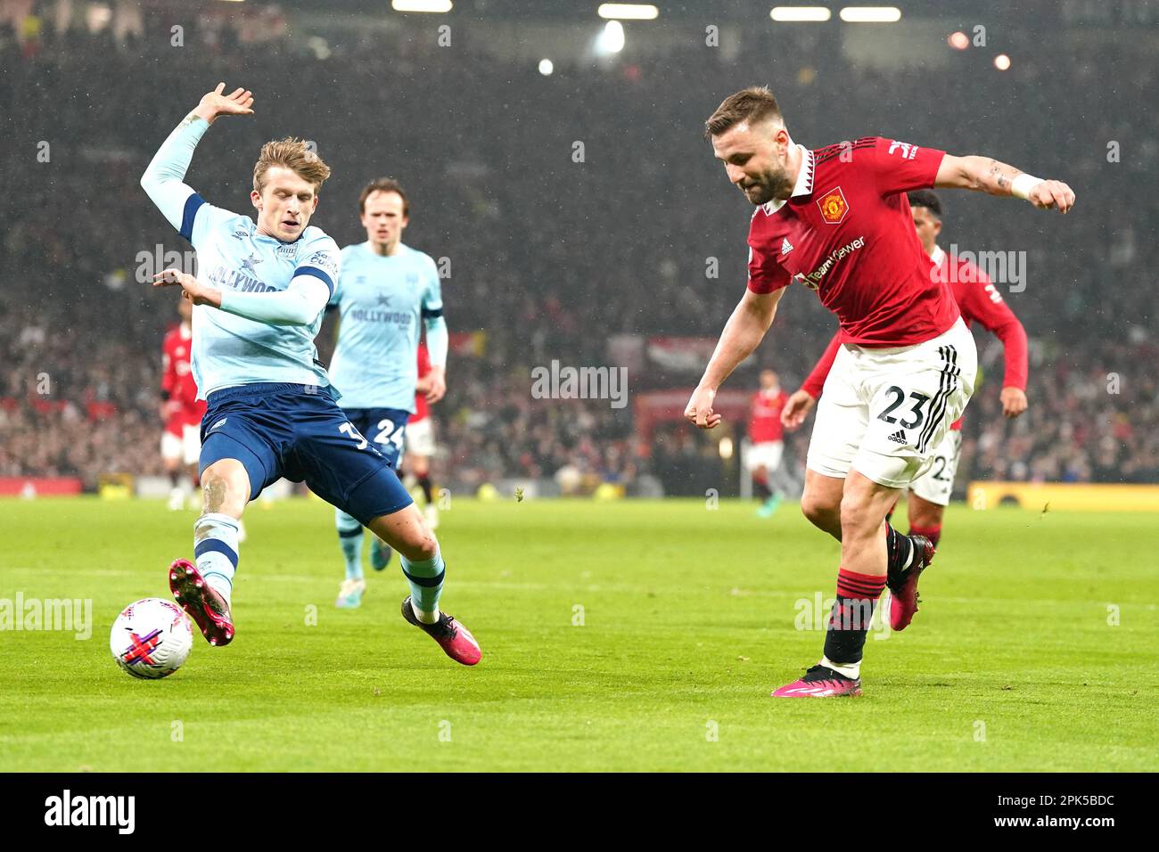 Manchester United's Luke Shaw (right) attempts a cross passed Brentford ...