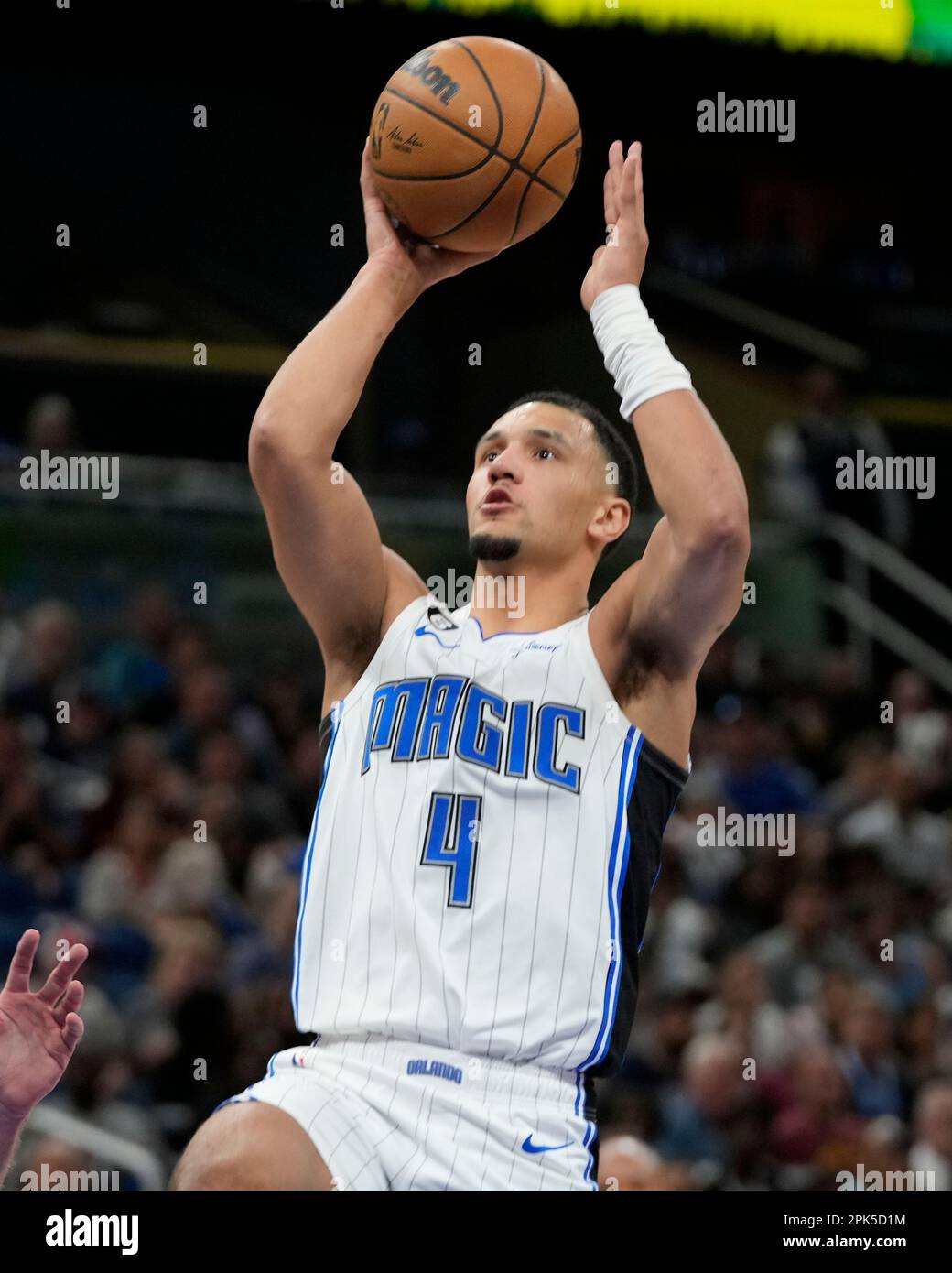 Orlando Magic's Jalen Suggs (4) takes a shot over Cleveland Cavaliers' Dean  Wade, left, during the