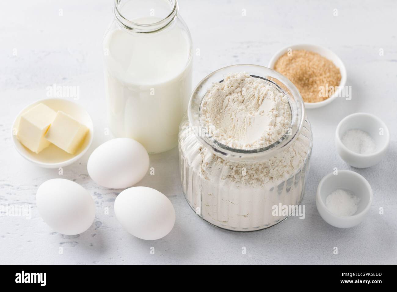 Ingredients for homemade pancakes milk, flour, eggs, butter, sugar