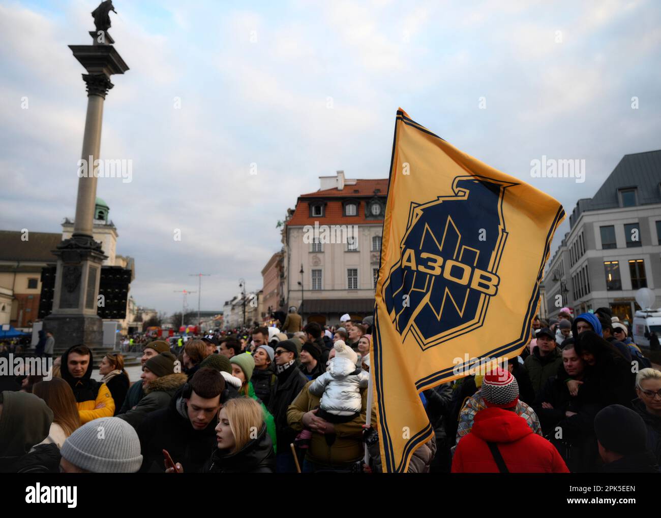 Warsaw, Poland. 05th Apr, 2023. A woman waves an Azov Assault Brigade flag as hundreds gather to see Volodymyr Zelensky speak at the Royal Castle in Warsaw, Poland on 05 April, 2023. Ukrainian President Volodymyr Zelensky is visiting Poland on Wednesday to meet with his Polish counterpart Andrzej Duda and make a public appearance meeting with Ukrainian and Polish citizens in Warsaw. (Photo by Jaap Arriens/ Credit: Sipa USA/Alamy Live News Stock Photo