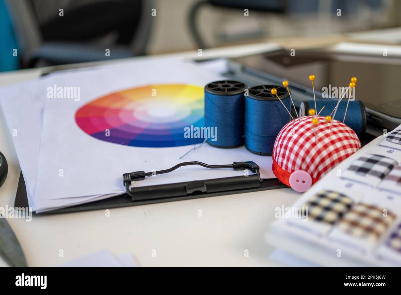 Sewing machine and accessories on table at dressmaking workshop studio Stock Photo