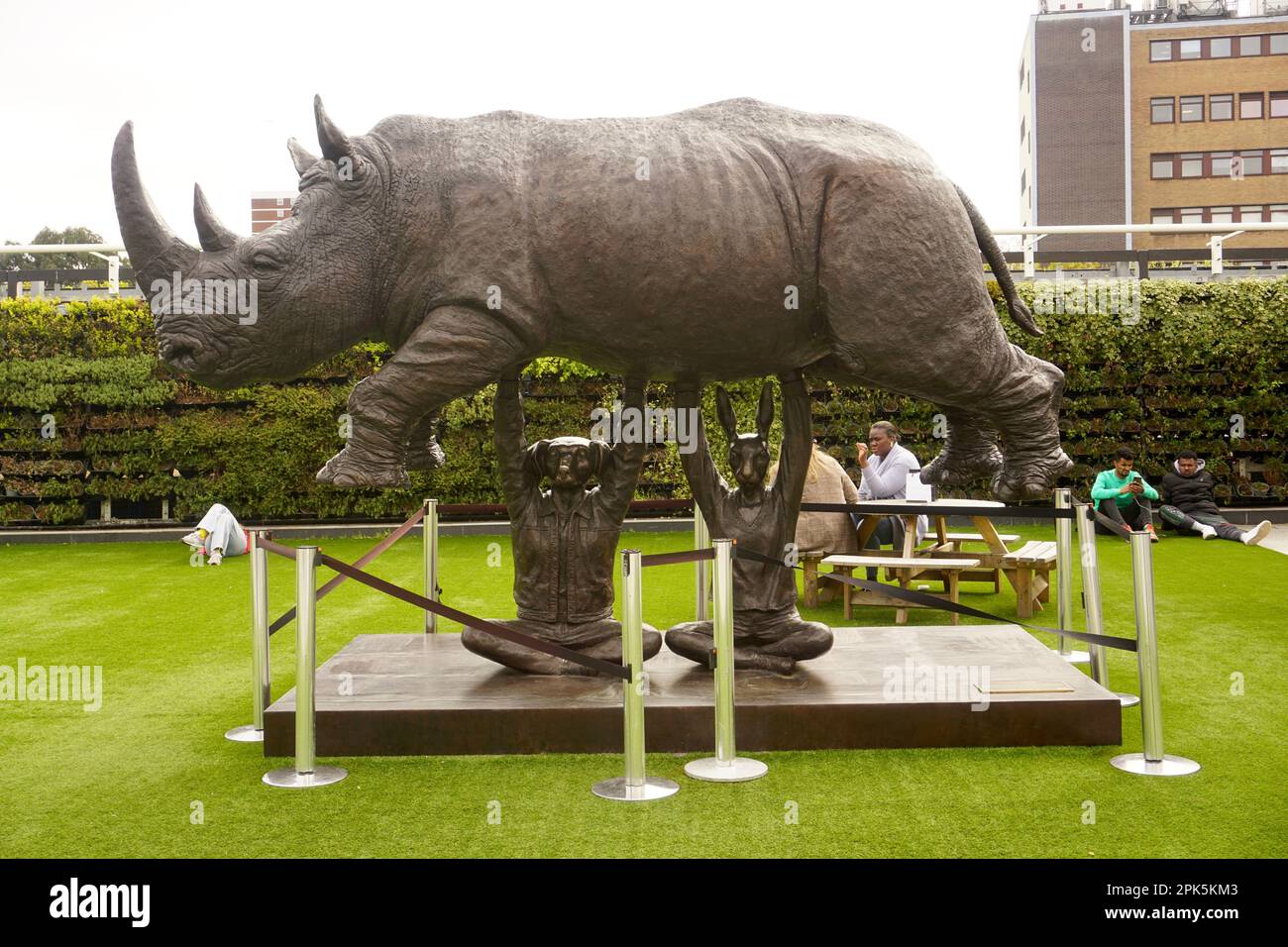 Rise Up Rhino statue in Westfield Shopping Centre, White City, lLondon, United Kingdom Stock Photo