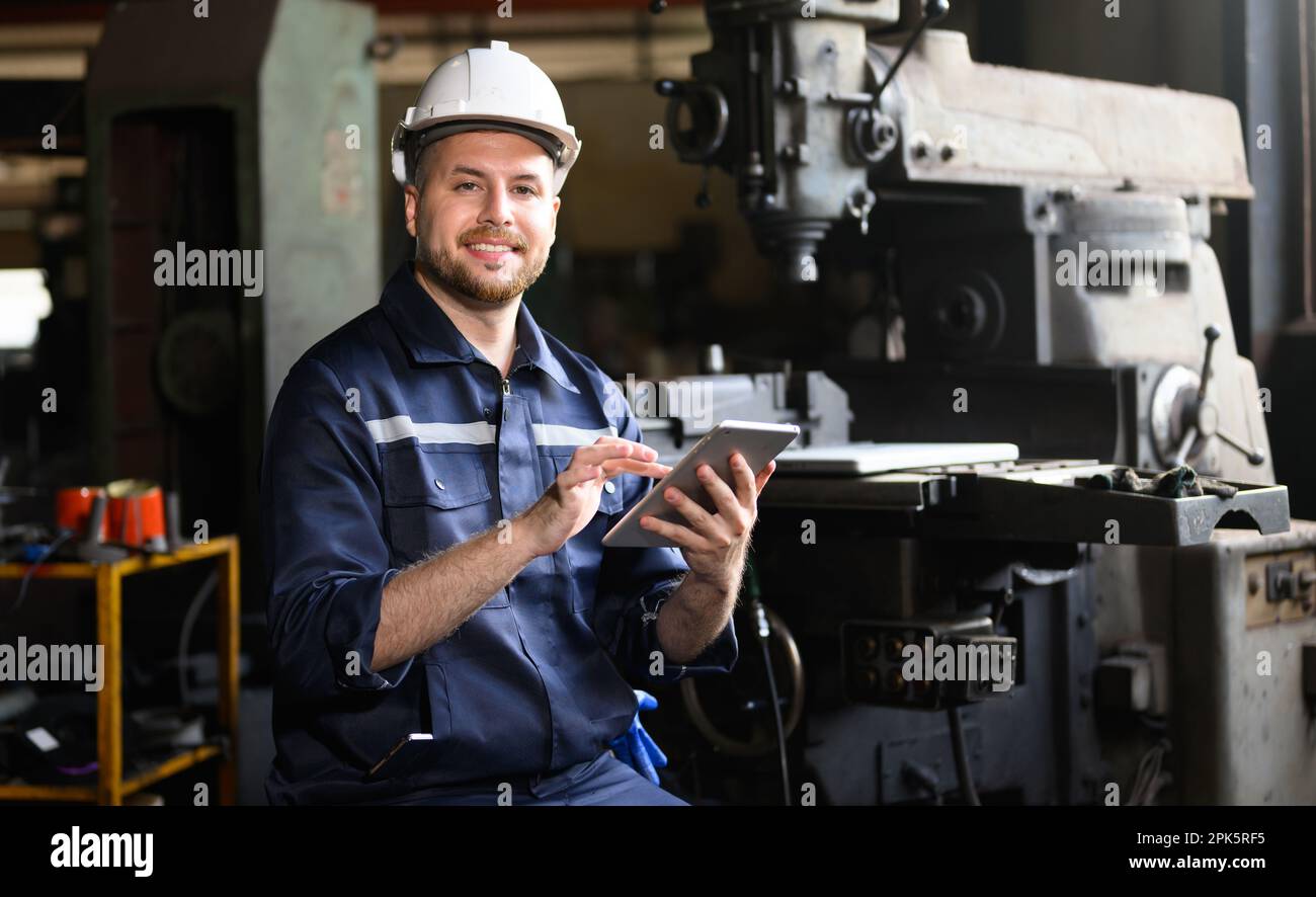 Professional male technician engineer using tablet checking machine Stock Photo