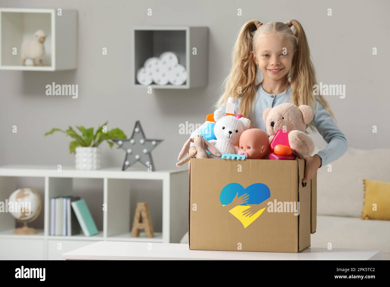 Humanitarian aid for Ukrainian refugees. Cute little girl holding
