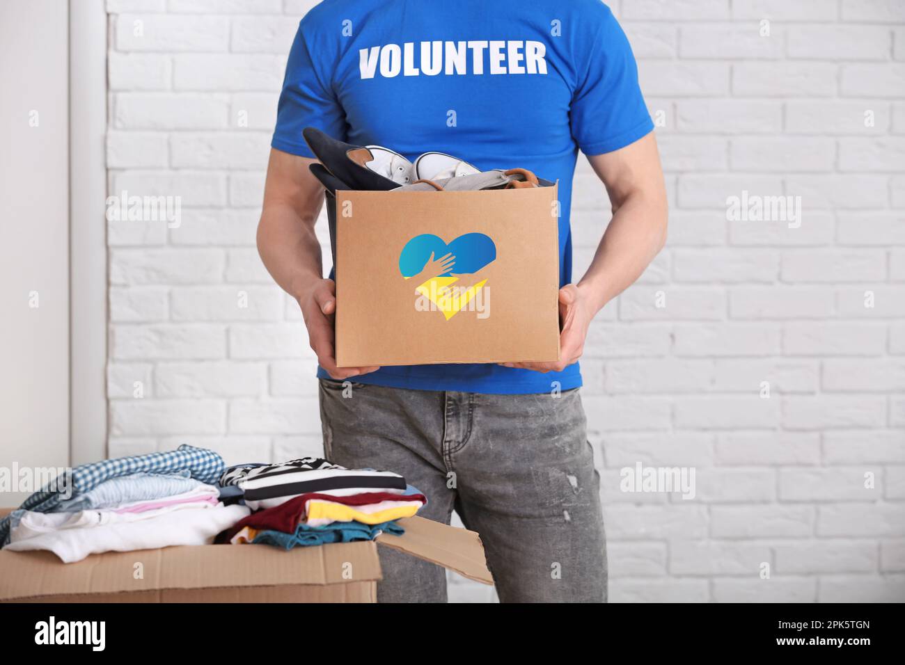 Humanitarian aid for Ukrainian refugees. Volunteer holding donation box
