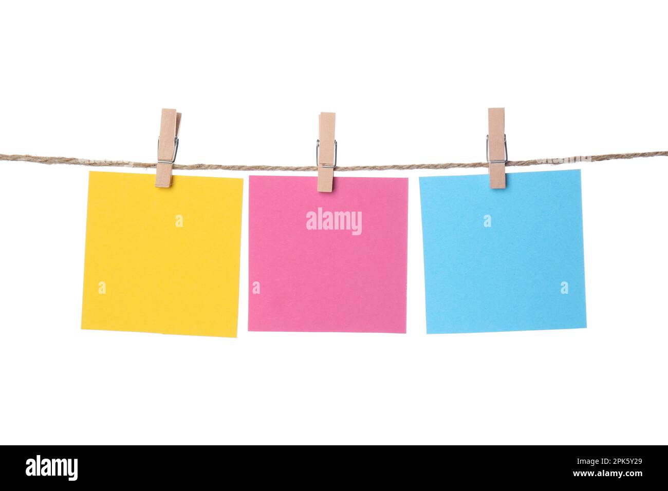 Clothespins with empty notepapers on string against white background. Space for text Stock Photo