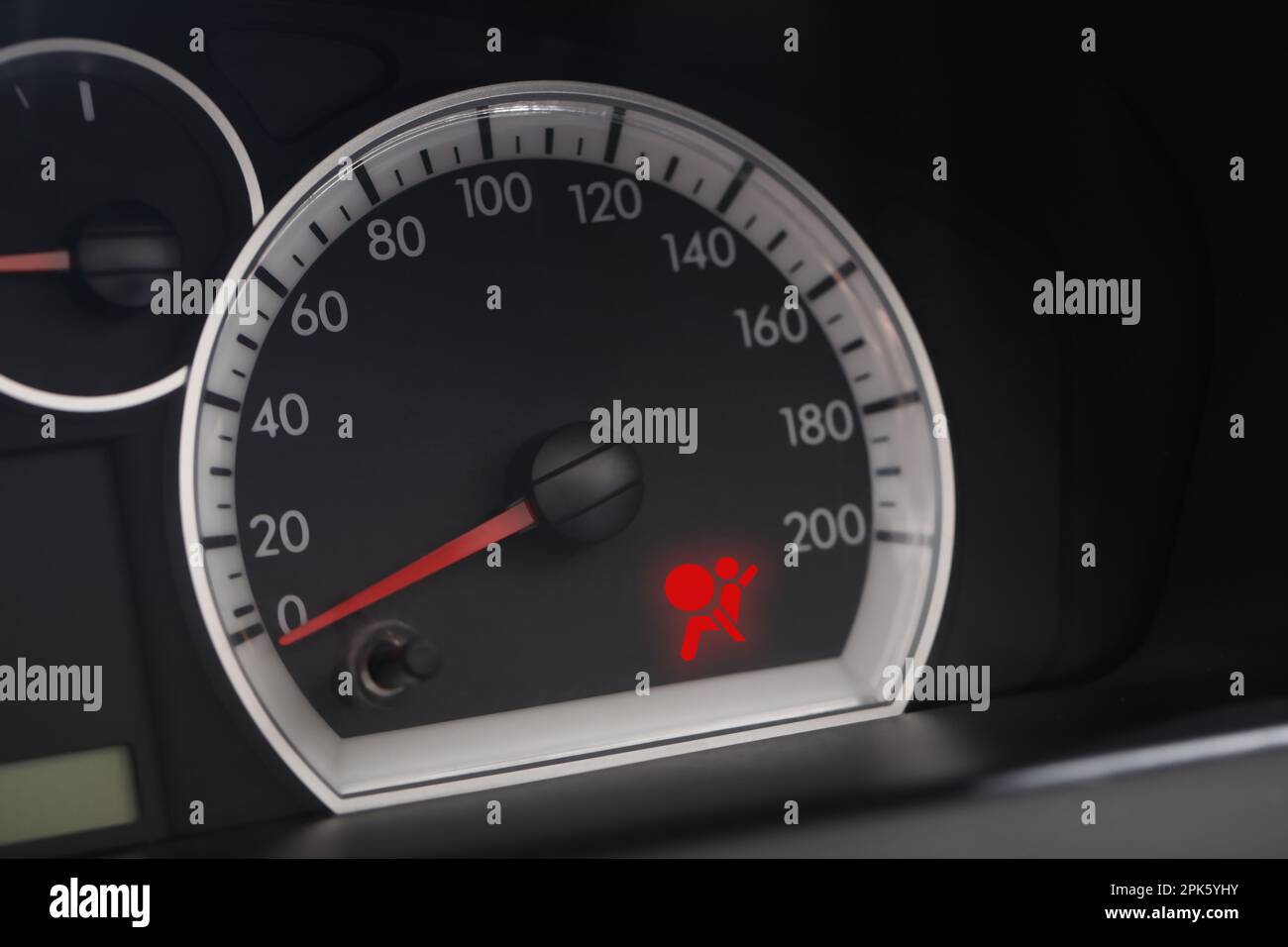 Closeup view of dashboard with warning icon check airbag system in car