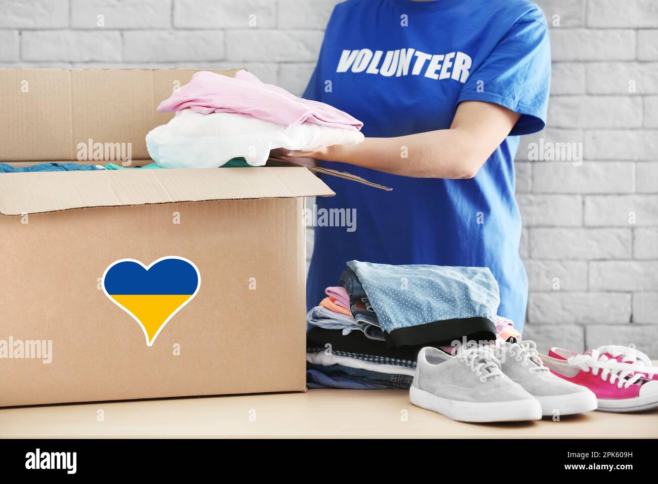 Humanitarian aid for Ukrainian refugees. Volunteer putting clothes into