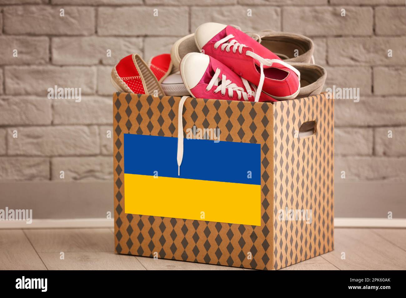 Humanitarian aid for Ukrainian refugees. Donation box with shoes on