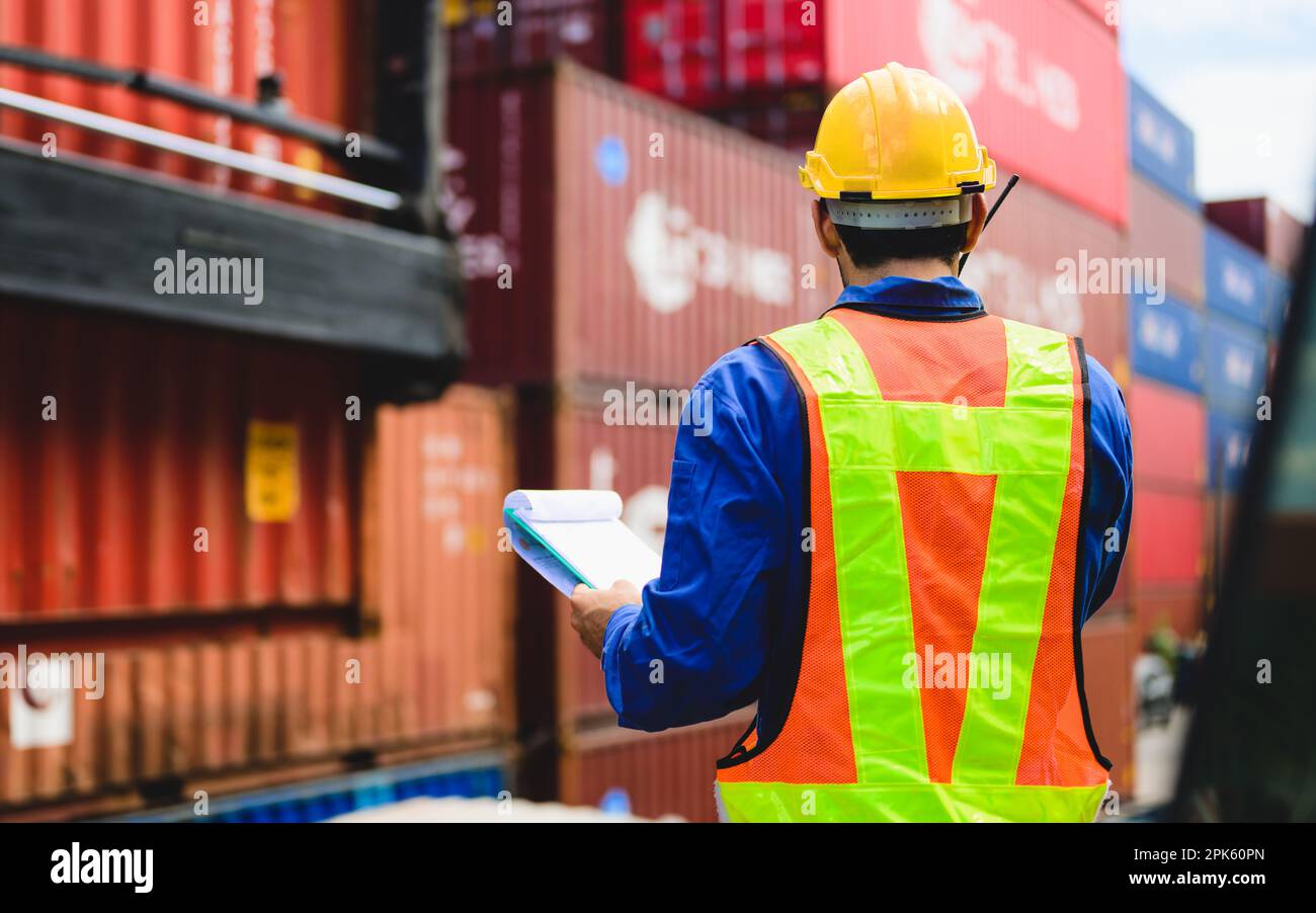 Industrial engineer worker working at overseas shipping container yard ...