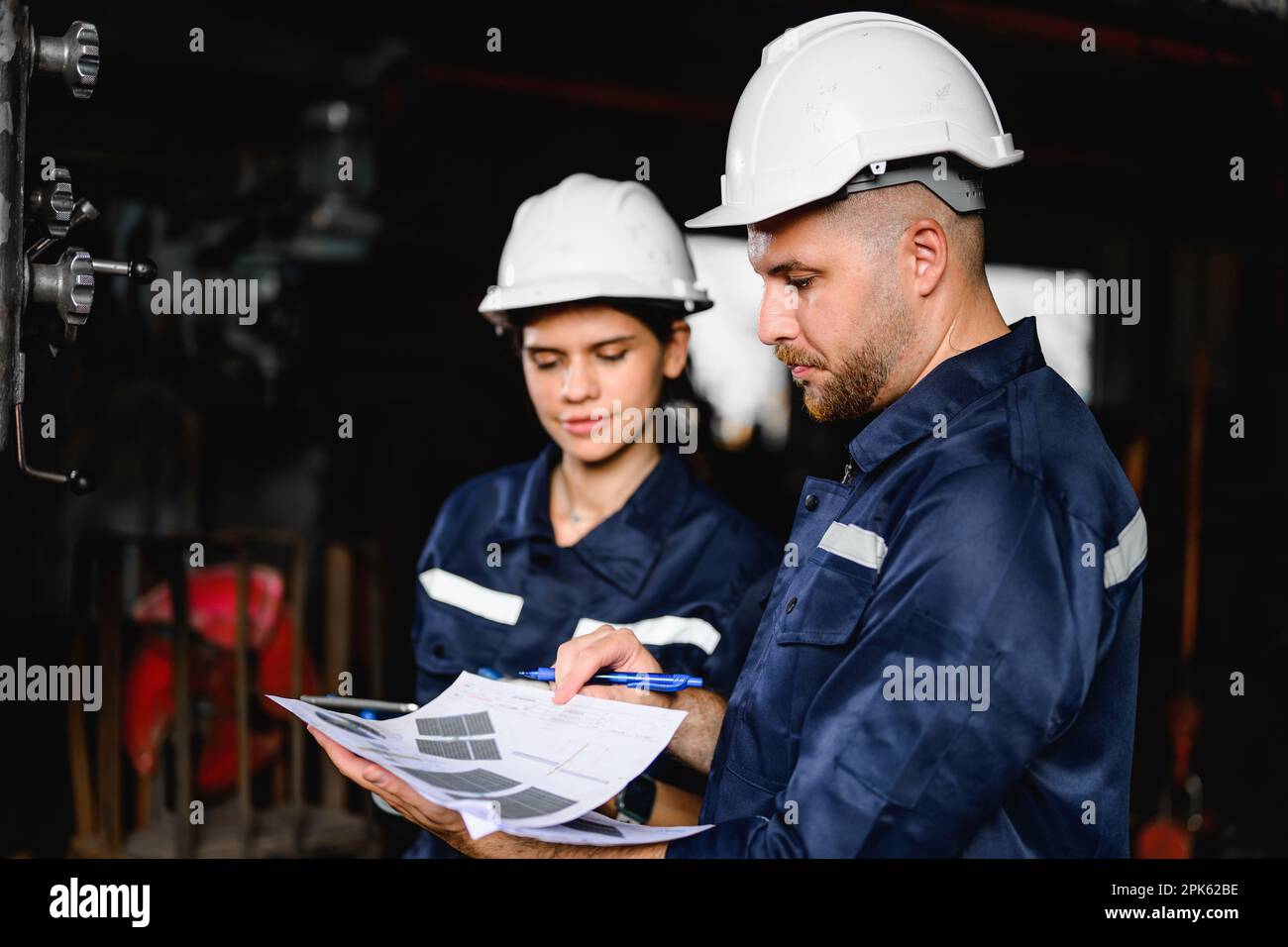 Two technicians engineers workers holding tablet checking Stock Photo