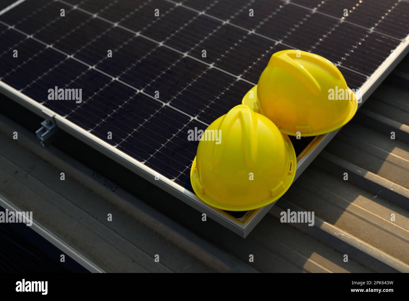Solar Farm Mask Yellow safety helmets on solar panels at solar cell farm power plant ...