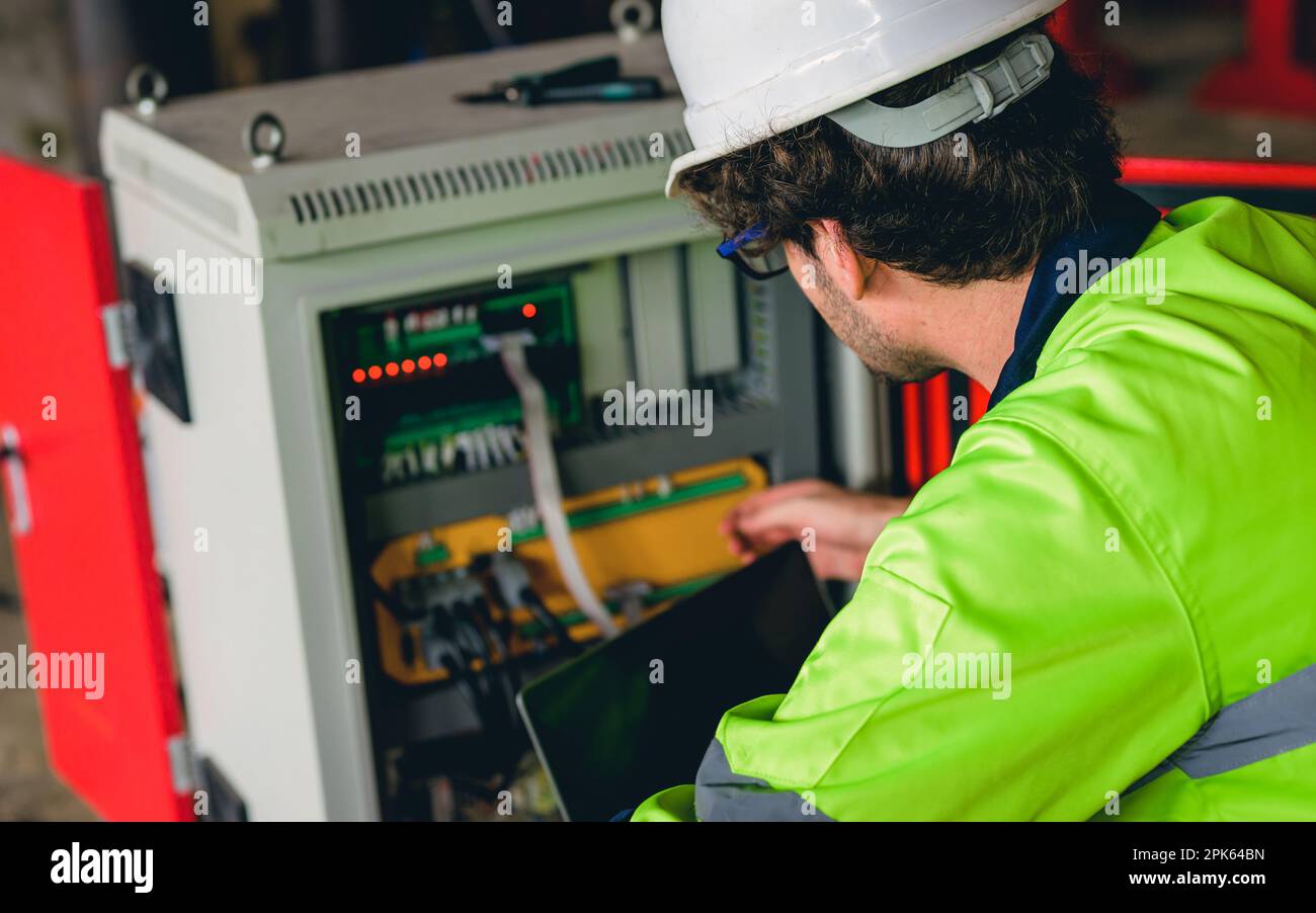 Technician engineer checking and repairing automatic robotic machine ...