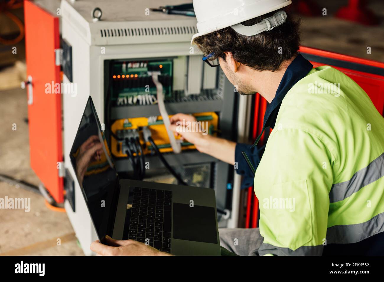 Engineer Reparing Machine Technician engineer checking and repairing automatic robotic machine ...