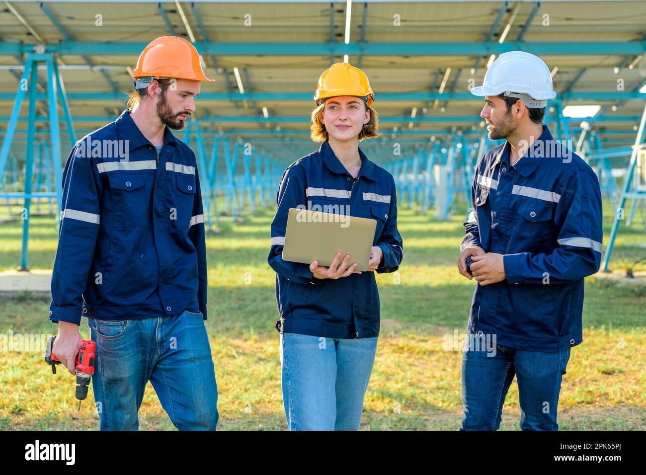 Workers installing solar panels, Engineer team at solar panel farm ...