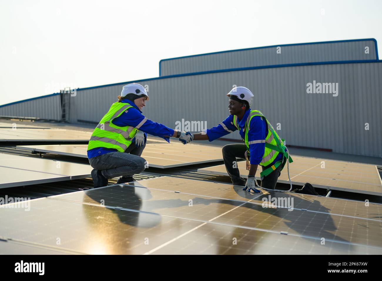 Two engineers technicians shacking hands together with successful project  Stock Photo
