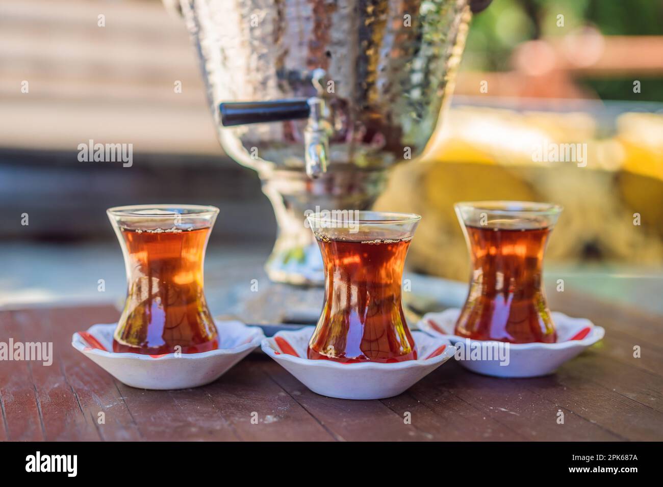 https://c8.alamy.com/comp/2PK687A/drinking-traditional-turkish-tea-with-turkish-tea-cup-and-copper-tea-pot-2PK687A.jpg