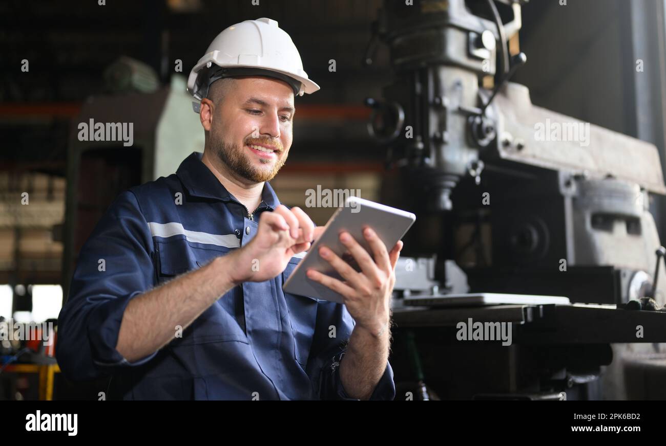 Professional male technician engineer using tablet checking machine Stock Photo
