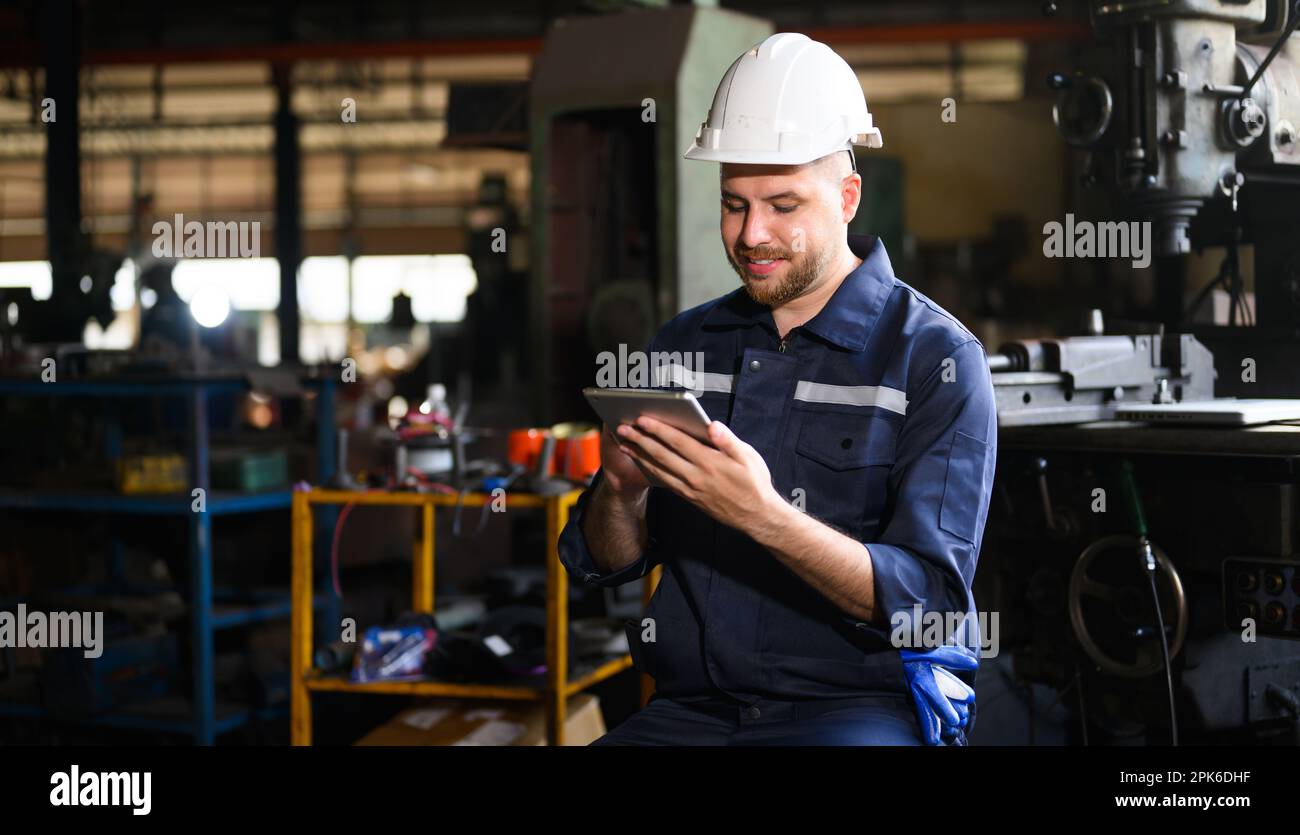 Professional male technician engineer using tablet checking machine Stock Photo