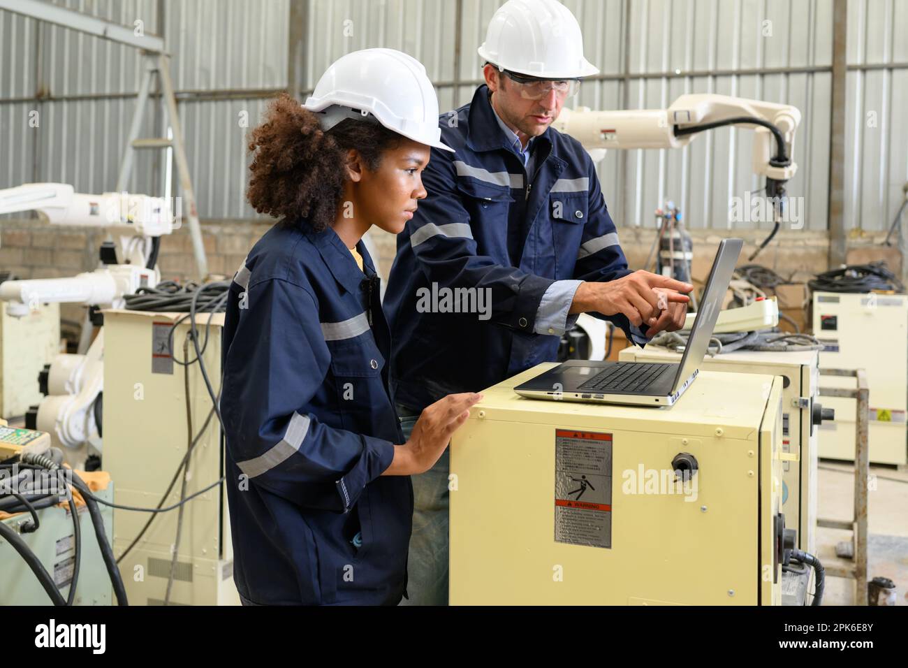Engineer technician controlling robotic hi-res stock photography and ...