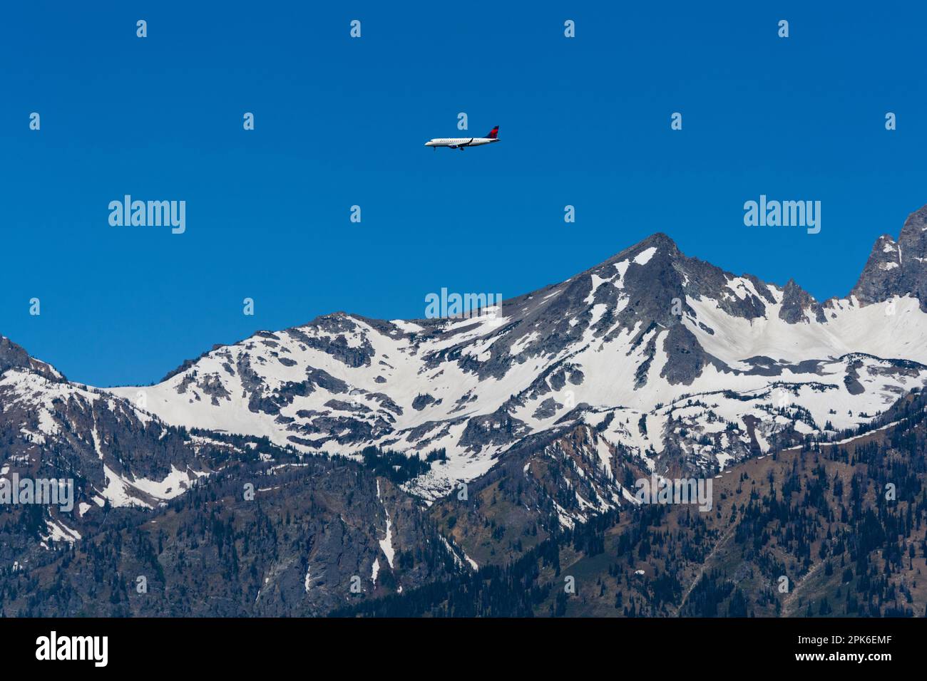 Mountains covered in snow, plane in sky, Wedge Mountain, British Columbia, Canada Stock Photo