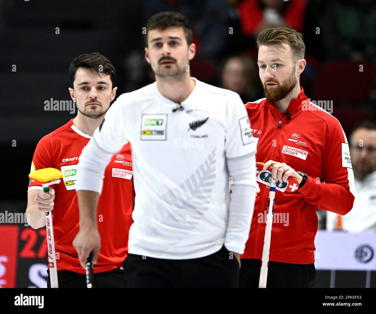 Ottawa, Can. 05th Apr, 2023. Switzerland fourth Benoit Schwarz, left, and  skip/third Yannick Schwaller confer, as New Zealand skip Anton Hood looks  up the sheet, at the Men's World Curling Championship in