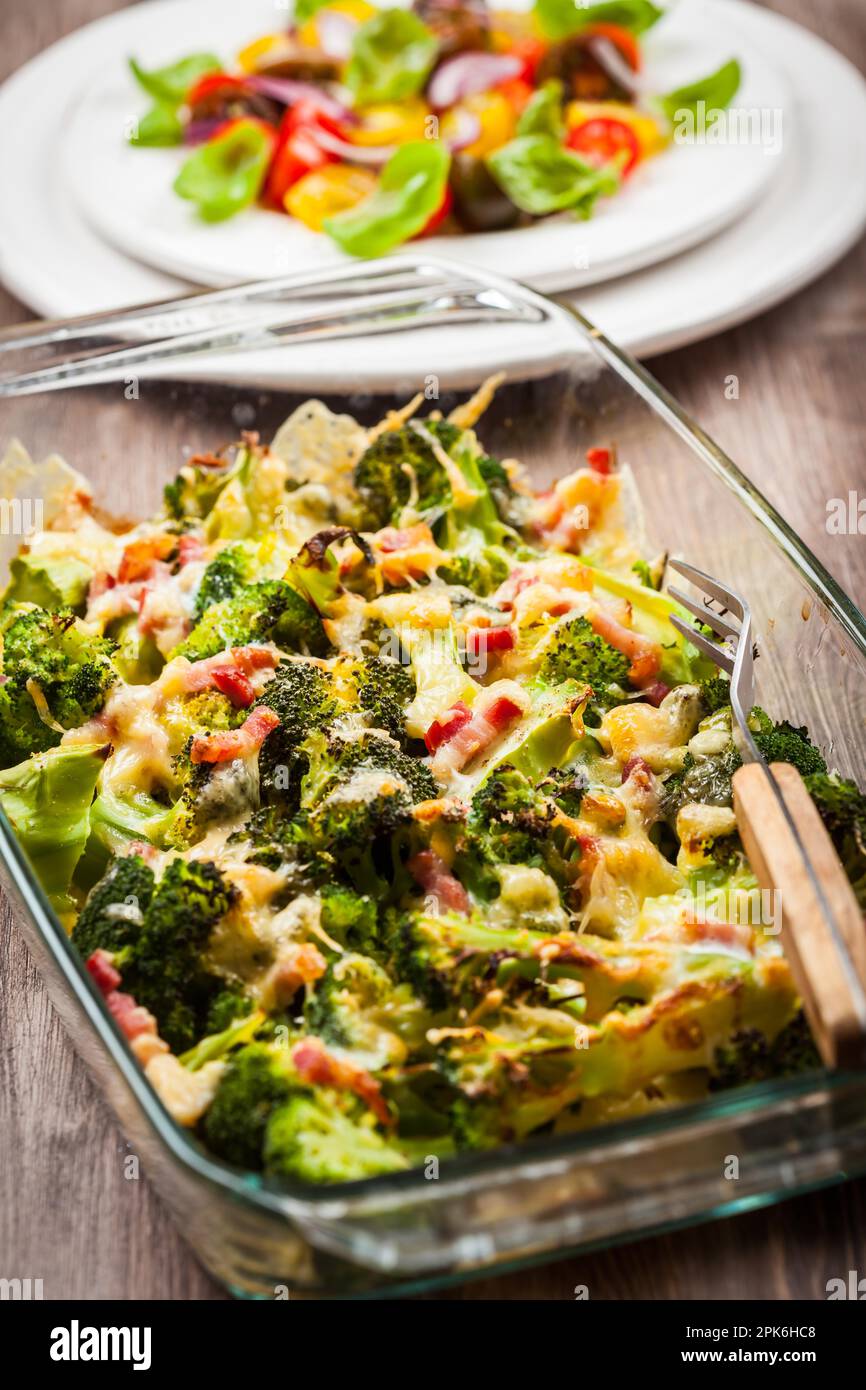 Baked broccoli with tomato salad Stock Photo
