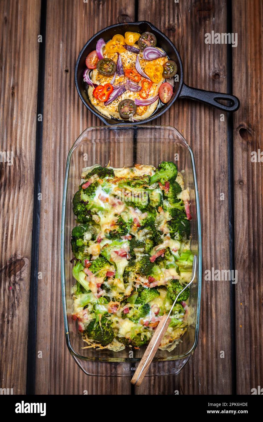 Baked broccoli with tomato salad Stock Photo