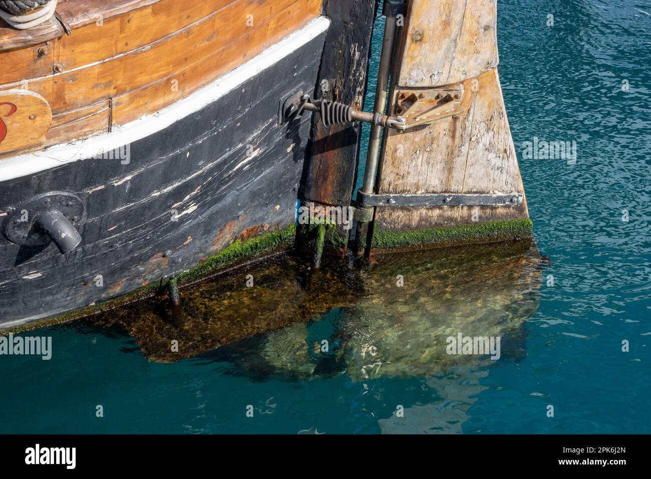 Detail of the stern and rudder of an old wooden ship in the