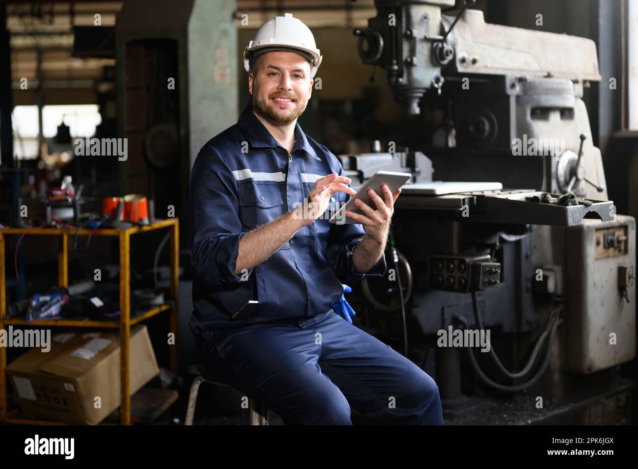 Professional male technician engineer using tablet checking machine Stock Photo