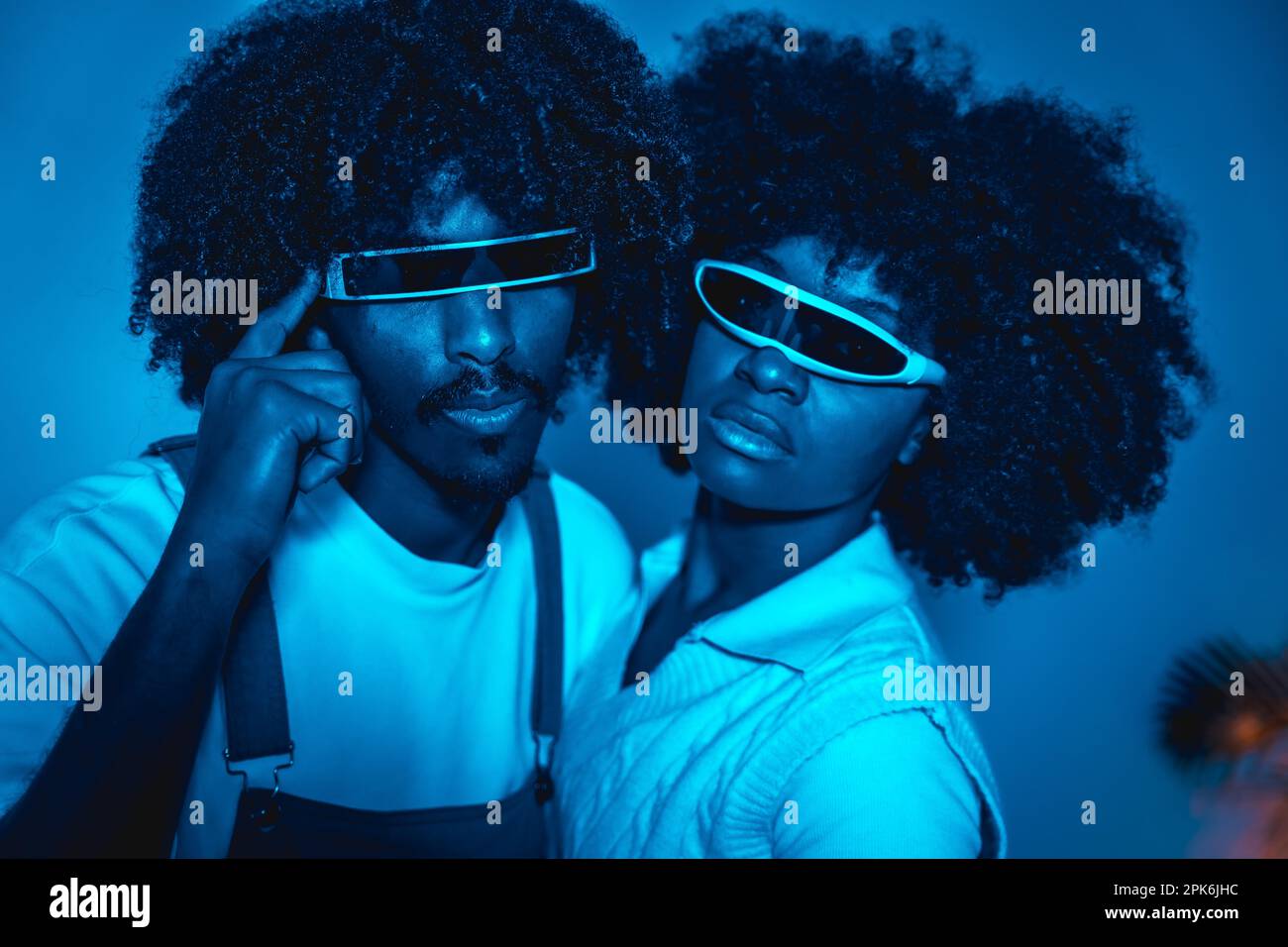 Young african american couple smiling in futuristic glasses with afro hair, modern future concept, science entertainment, digital technology Stock Photo